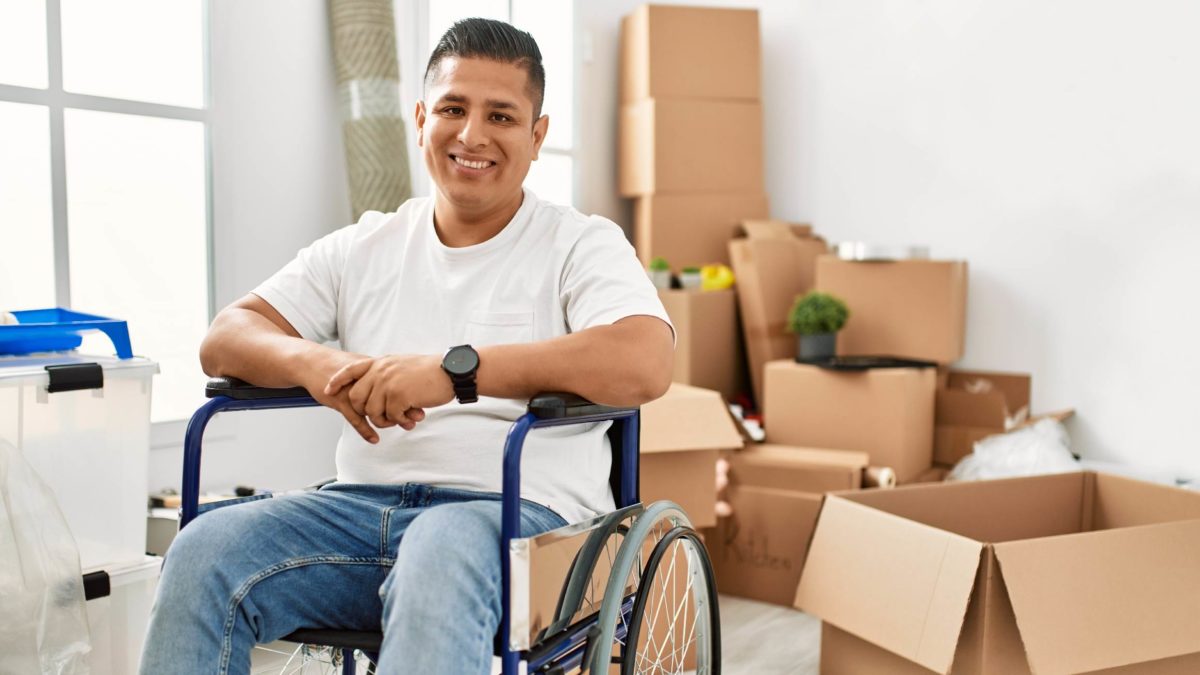 Hispanic male in wheelchair moving into new home.