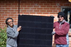 two people with solar panel