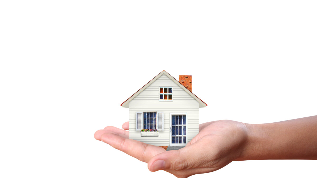 Mortgage concept by house in hand
